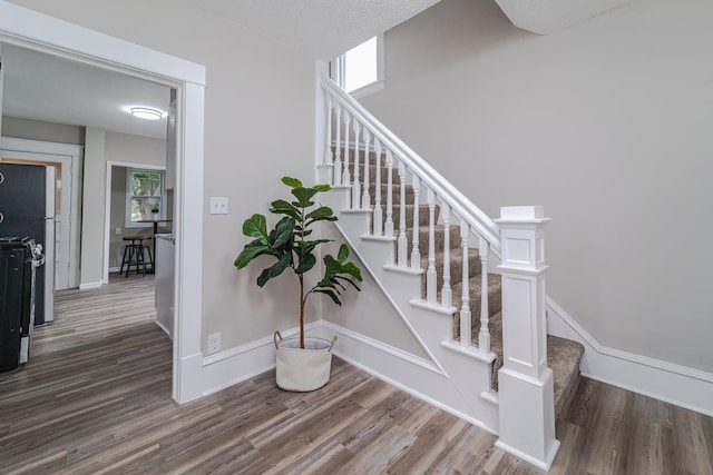 2156 Saint Anthony Ave, Saint Paul, MN 55104 - stairway featuring wood finished floors and baseboards