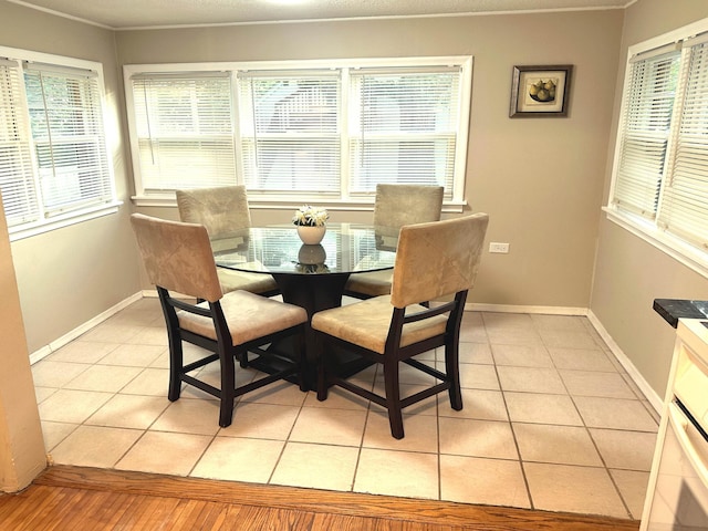 1699 Malvern St, Lauderdale, MN 55113 - dining area with plenty of natural light, light tile patterned flooring, and ornamental molding