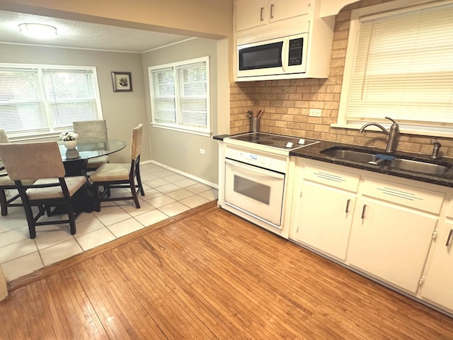1699 Malvern St, Lauderdale, MN 55113 - kitchen with white appliances, dark countertops, and plenty of natural light