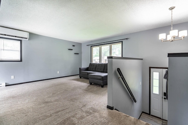 516 Gustavus Ave, Fergus Falls, MN 56537 - rec room with a wall mounted air conditioner, a chandelier, a textured ceiling, and carpet flooring