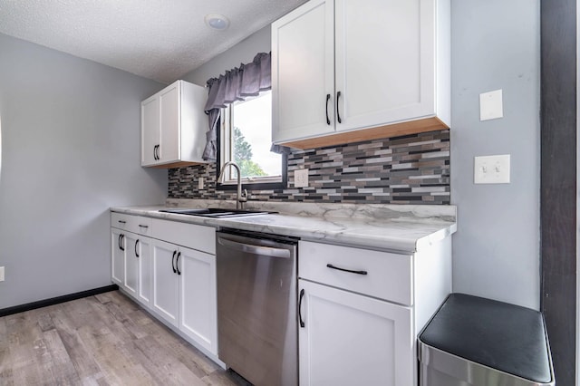 516 Gustavus Ave, Fergus Falls, MN 56537 - kitchen featuring stainless steel dishwasher, light wood-type flooring, tasteful backsplash, white cabinetry, and a textured ceiling