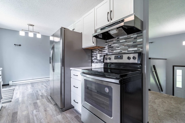 516 Gustavus Ave, Fergus Falls, MN 56537 - kitchen featuring stainless steel appliances, under cabinet range hood, baseboard heating, a textured ceiling, and tasteful backsplash
