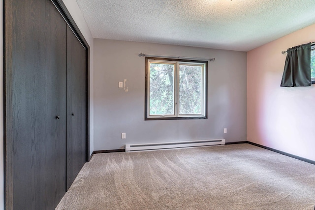 516 Gustavus Ave, Fergus Falls, MN 56537 - unfurnished bedroom featuring a baseboard radiator, carpet flooring, a closet, and a textured ceiling
