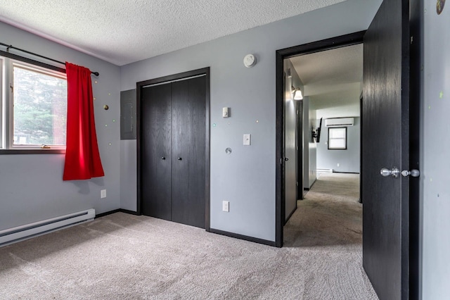 516 Gustavus Ave, Fergus Falls, MN 56537 - unfurnished bedroom with electric panel, carpet, a textured ceiling, a closet, and a baseboard radiator