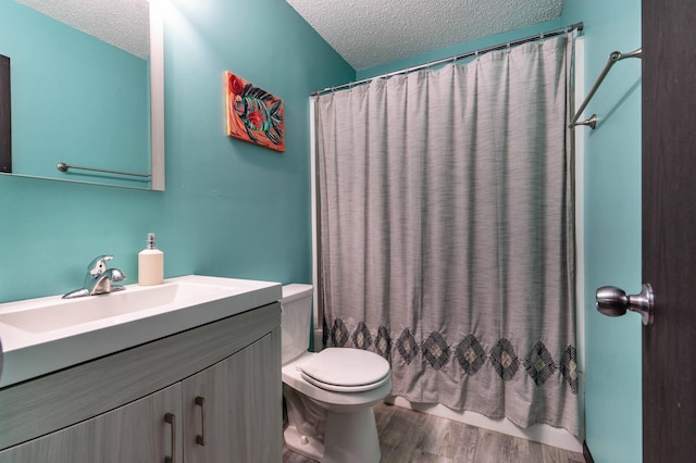 516 Gustavus Ave, Fergus Falls, MN 56537 - bathroom with a textured ceiling, vanity, wood finished floors, and a shower with shower curtain
