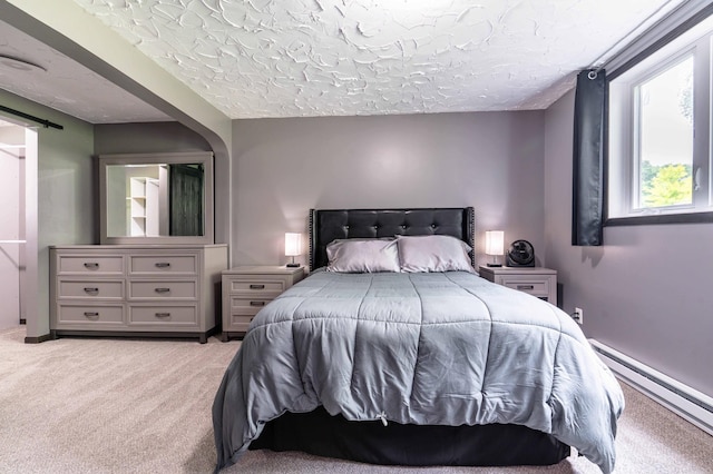 516 Gustavus Ave, Fergus Falls, MN 56537 - bedroom with a baseboard radiator, light colored carpet, and a textured ceiling