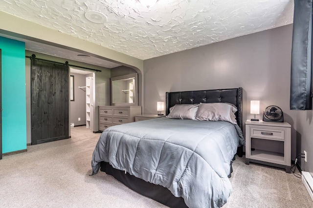 516 Gustavus Ave, Fergus Falls, MN 56537 - bedroom featuring carpet, a barn door, and a textured ceiling