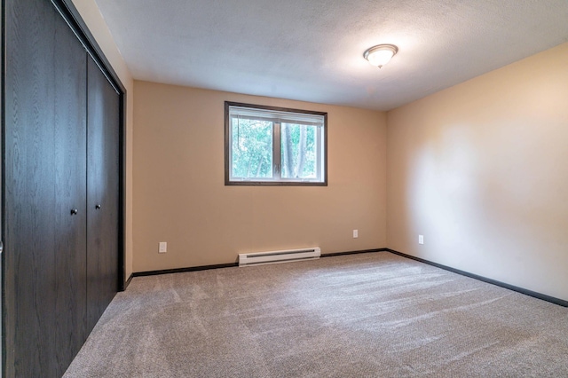 516 Gustavus Ave, Fergus Falls, MN 56537 - unfurnished bedroom with a baseboard radiator, carpet, and a closet