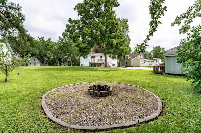 516 Gustavus Ave, Fergus Falls, MN 56537 - view of grassy yard featuring a fire pit and a deck