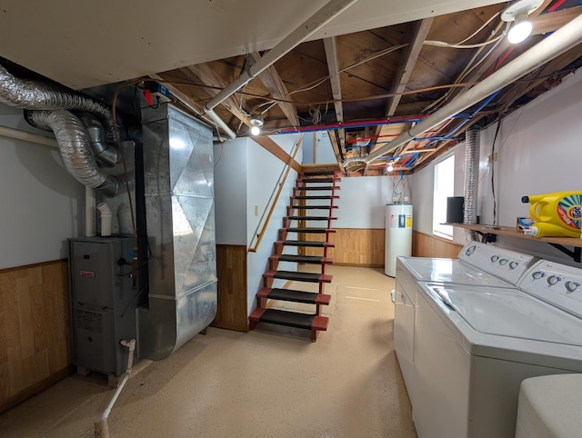 202 Hill St, Russell, MN 56169 - below grade area with washer and dryer, electric water heater, heating unit, a wainscoted wall, and wood walls