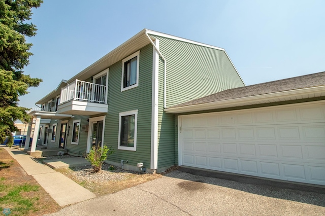 3209 15th Ave S Unit B, Fargo, ND 58103 - view of front of house with a balcony, driveway, and an attached garage