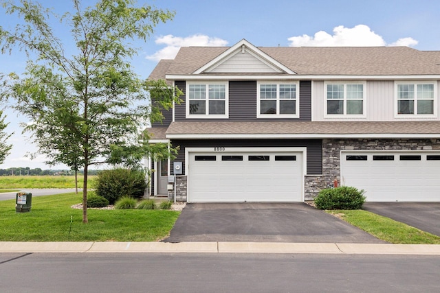 8800 Granite Pass, Woodbury, MN 55129 - view of front of house featuring asphalt driveway, an attached garage, a front lawn, and a shingled roof