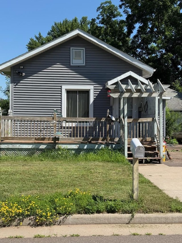 1736 Lombard St, Chippewa Falls, WI 54729 - view of front of property featuring a deck and a front yard