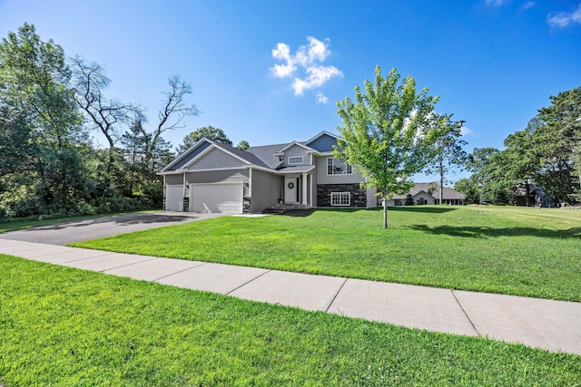 13143 Jefferson St, Becker, MN 55308 - view of front facade with a garage, a front yard, driveway, and stone siding