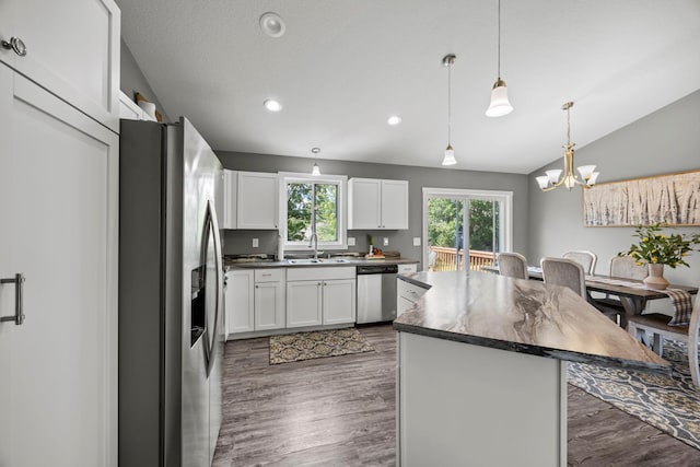 13143 Jefferson St, Becker, MN 55308 - kitchen with appliances with stainless steel finishes, a kitchen island, white cabinets, a chandelier, and dark countertops
