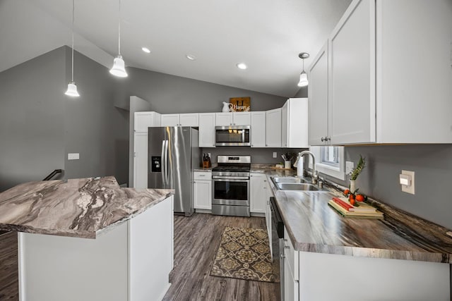 13143 Jefferson St, Becker, MN 55308 - kitchen with stainless steel appliances, vaulted ceiling, dark wood-type flooring, white cabinetry, and hanging light fixtures