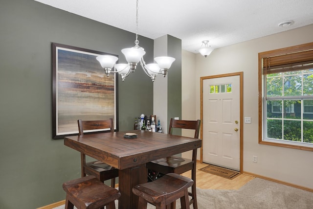 14301 Banyan Ln, Rosemount, MN 55068 - dining area featuring light wood finished floors and a chandelier
