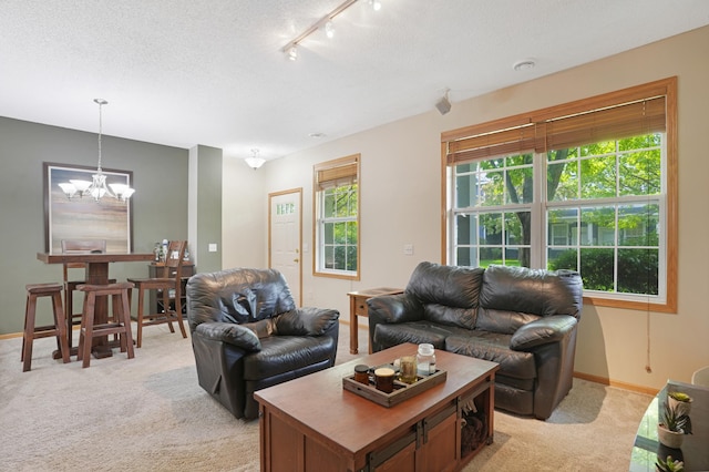 14301 Banyan Ln, Rosemount, MN 55068 - living area featuring light colored carpet, a chandelier, and track lighting