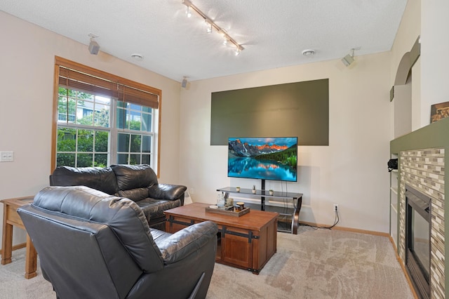 14301 Banyan Ln, Rosemount, MN 55068 - living area featuring track lighting, a textured ceiling, light colored carpet, and a fireplace