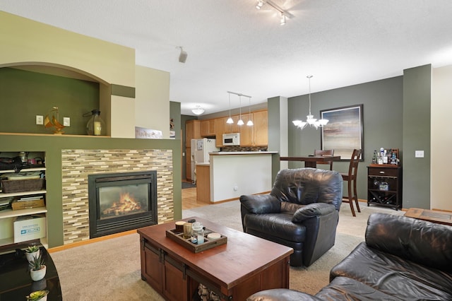 14301 Banyan Ln, Rosemount, MN 55068 - living room featuring a chandelier, a tile fireplace, light colored carpet, and rail lighting