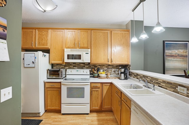 14301 Banyan Ln, Rosemount, MN 55068 - kitchen with white appliances, light wood-style floors, light countertops, and backsplash