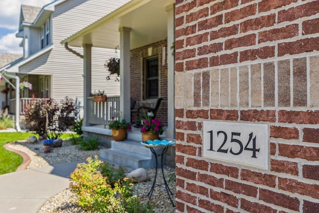 1254 129th Ln NW, Coon Rapids, MN 55448 - view of exterior entry featuring a porch and brick siding