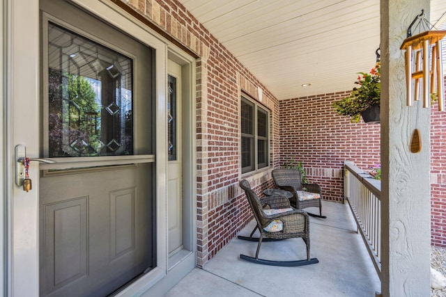 1254 129th Ln NW, Coon Rapids, MN 55448 - doorway to property featuring brick siding and a porch