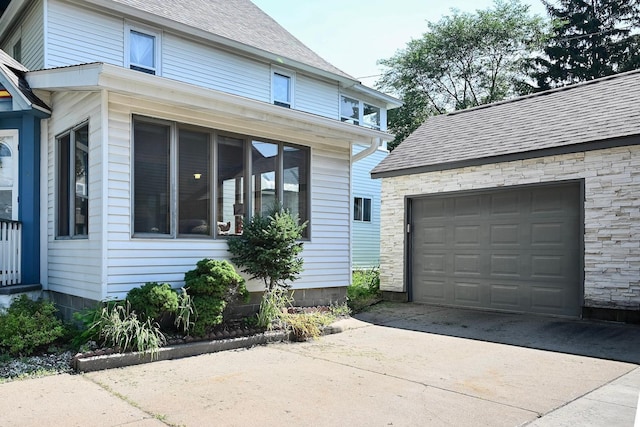 366 Kansas St, Winona, MN 55987 - view of side of property featuring concrete driveway and roof with shingles