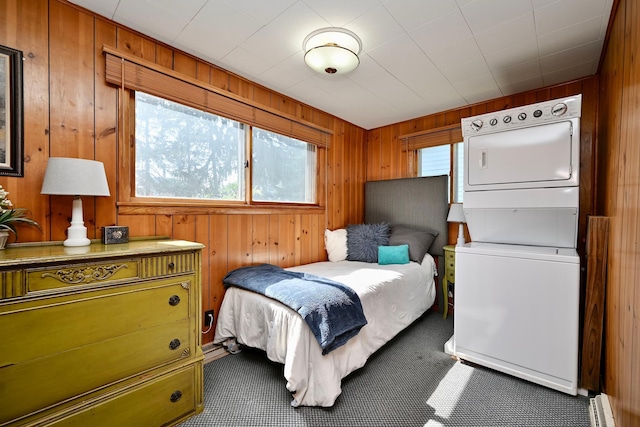 366 Kansas St, Winona, MN 55987 - bedroom featuring estacked washer and dryer, wood walls, and carpet floors