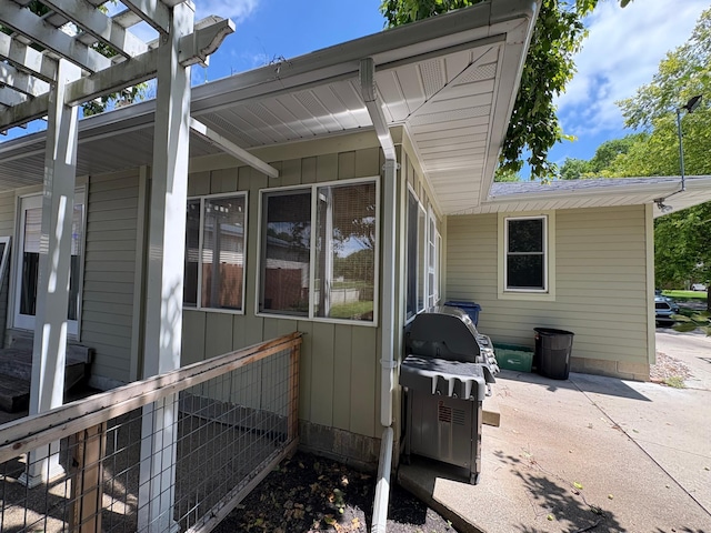 207 Meadow Ln, Benson, MN 56215 - view of home's exterior featuring board and batten siding, a patio, and a pergola