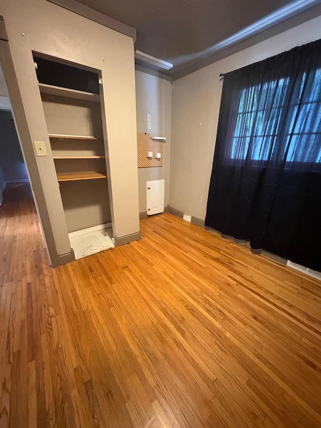 207 Meadow Ln, Benson, MN 56215 - unfurnished bedroom with wood finished floors and baseboards
