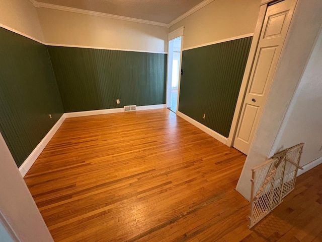 207 Meadow Ln, Benson, MN 56215 - spare room with hardwood / wood-style floors and crown molding