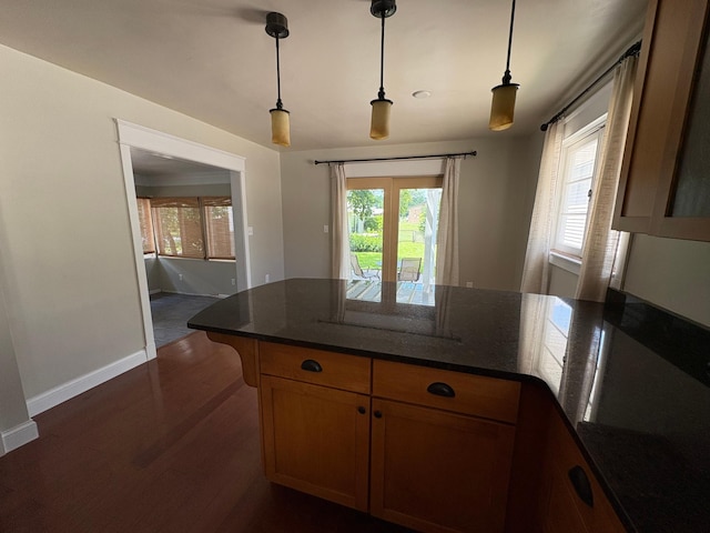 207 Meadow Ln, Benson, MN 56215 - kitchen with a peninsula, dark wood finished floors, decorative light fixtures, and dark stone counters