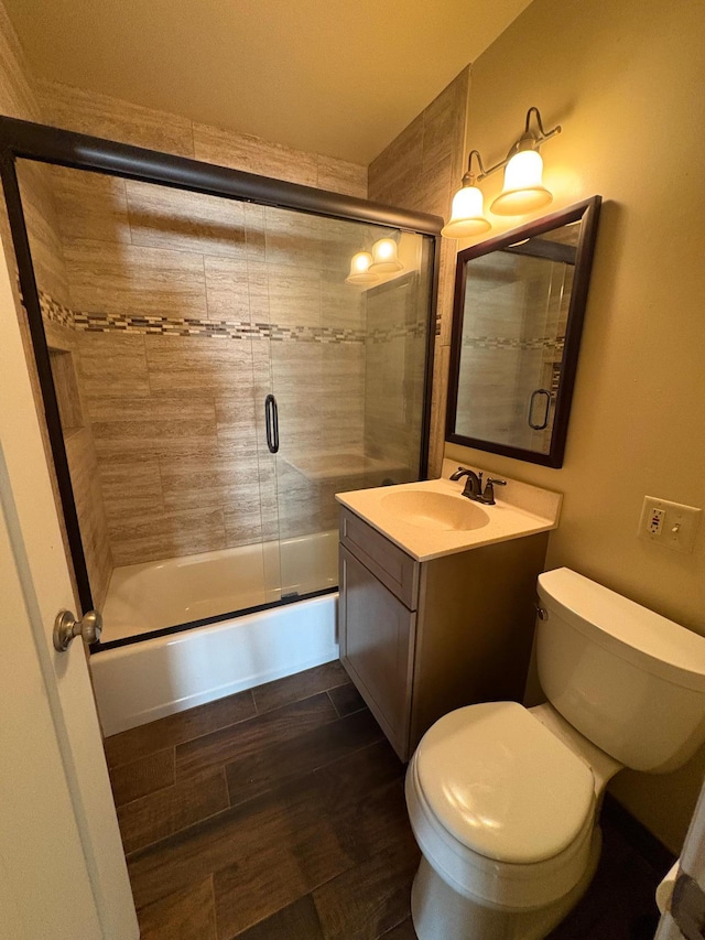 207 Meadow Ln, Benson, MN 56215 - full bath with combined bath / shower with glass door, vanity, and wood finished floors