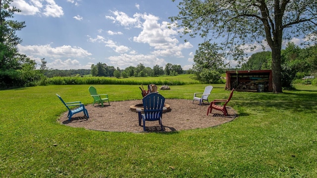 W13263 Hutchinson Rd, Big Bend Twp, WI 54819 - view of play area featuring an outdoor fire pit and a yard