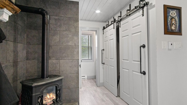 W13263 Hutchinson Rd, Big Bend Twp, WI 54819 - bathroom with wood finished floors, recessed lighting, a wood stove, and a baseboard heating unit