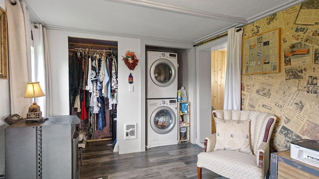 W13263 Hutchinson Rd, Big Bend Twp, WI 54819 - laundry room featuring stacked washer / drying machine, wood finished floors, heating unit, and ornamental molding