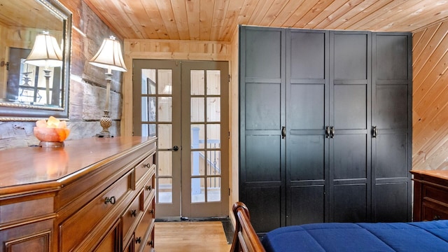 W13263 Hutchinson Rd, Big Bend Twp, WI 54819 - bedroom with wood walls, wood ceiling, french doors, and light wood finished floors