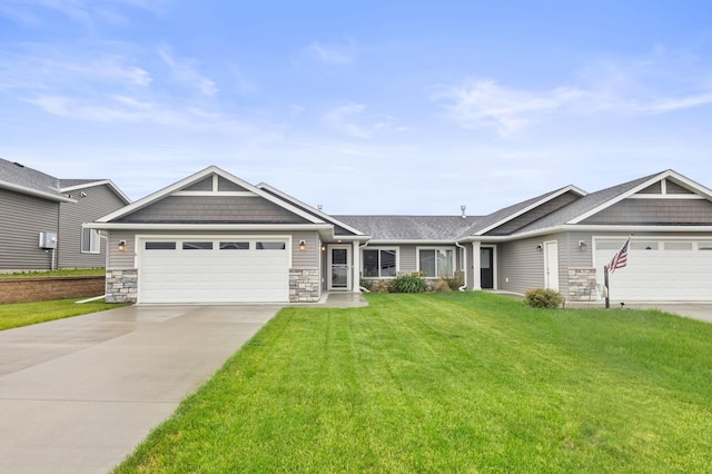 888 Tallgrass Ct, Wanamingo, MN 55983 - craftsman-style house with an attached garage, concrete driveway, a front lawn, and stone siding