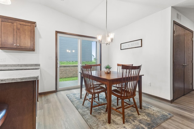 888 Tallgrass Ct, Wanamingo, MN 55983 - dining room with light wood-style floors, lofted ceiling, and a chandelier