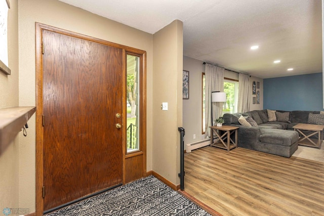 402 5th St NE, Barnesville, MN 56514 - foyer with a baseboard heating unit, wood finished floors, and recessed lighting