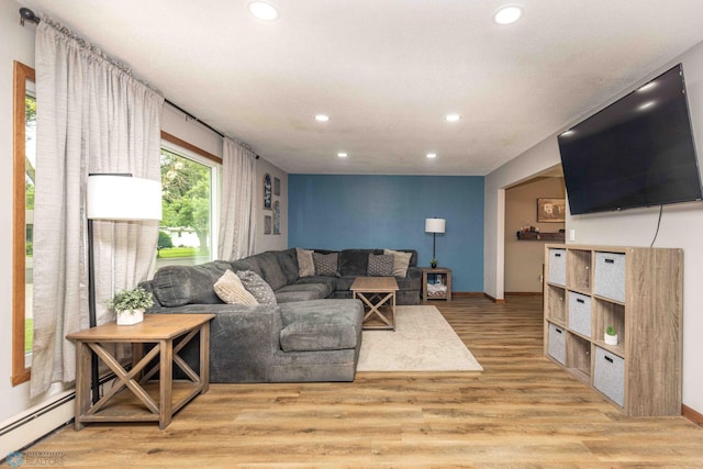 402 5th St NE, Barnesville, MN 56514 - living room with recessed lighting, light wood-style flooring, and a baseboard radiator