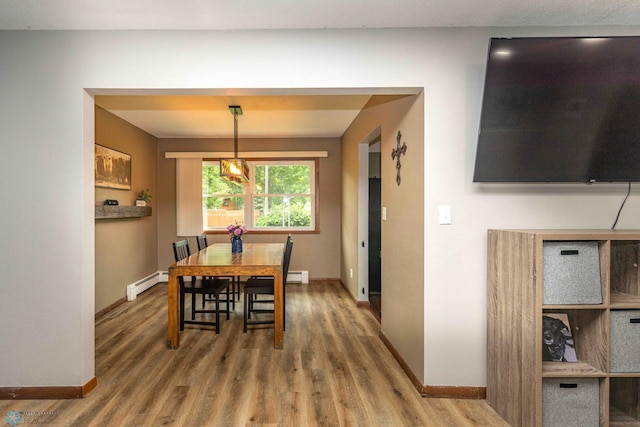 402 5th St NE, Barnesville, MN 56514 - dining room featuring a baseboard heating unit and wood finished floors