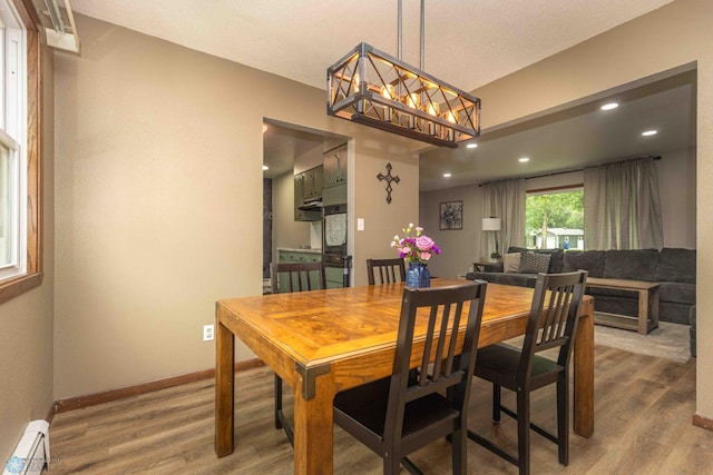 402 5th St NE, Barnesville, MN 56514 - dining area with baseboard heating, wood finished floors, and recessed lighting