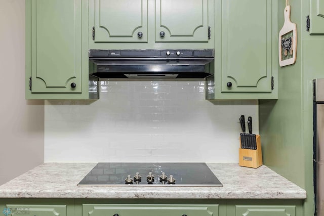 402 5th St NE, Barnesville, MN 56514 - kitchen featuring ventilation hood, green cabinetry, black electric cooktop, and decorative backsplash