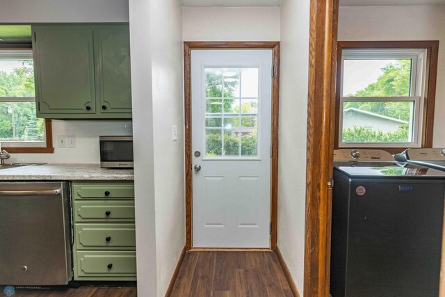 402 5th St NE, Barnesville, MN 56514 - kitchen with green cabinets, appliances with stainless steel finishes, dark wood-type flooring, light countertops, and separate washer and dryer