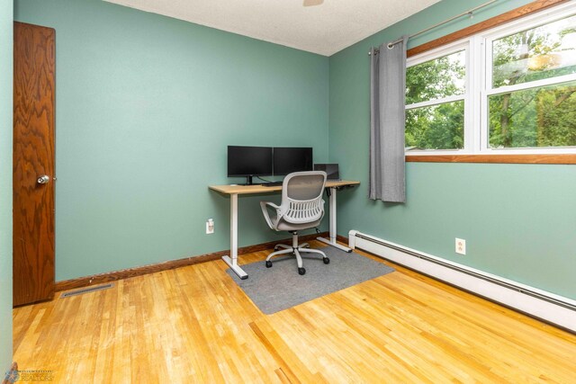 402 5th St NE, Barnesville, MN 56514 - office area with baseboard heating and wood finished floors