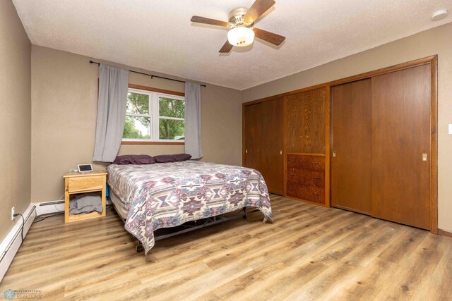402 5th St NE, Barnesville, MN 56514 - bedroom featuring wood finished floors, a closet, ceiling fan, and a textured ceiling
