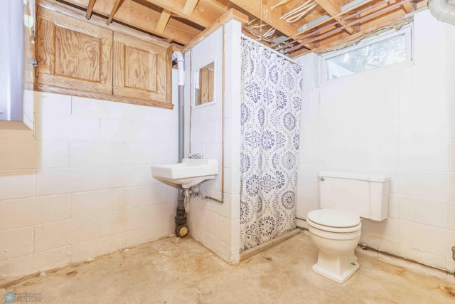 402 5th St NE, Barnesville, MN 56514 - bathroom with concrete floors and a shower with shower curtain
