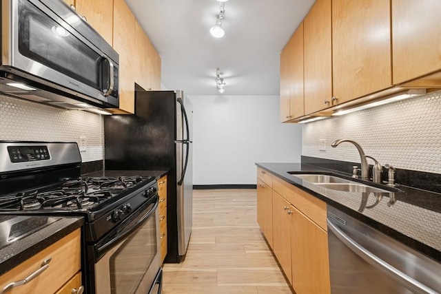 2800 44th St Unit 401, Minneapolis, MN 55410 - kitchen featuring stainless steel appliances, tasteful backsplash, light wood finished floors, and dark stone countertops